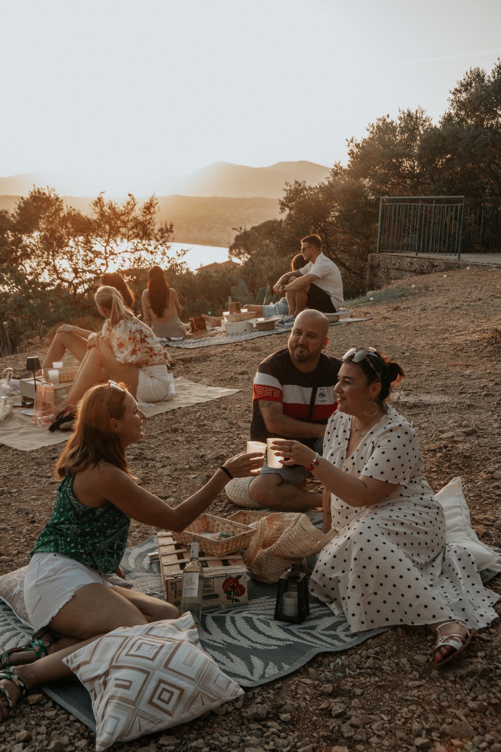 The Nice Picnic — guests sharing a sunset picnic on a hillside overlooking the Mediterranean
